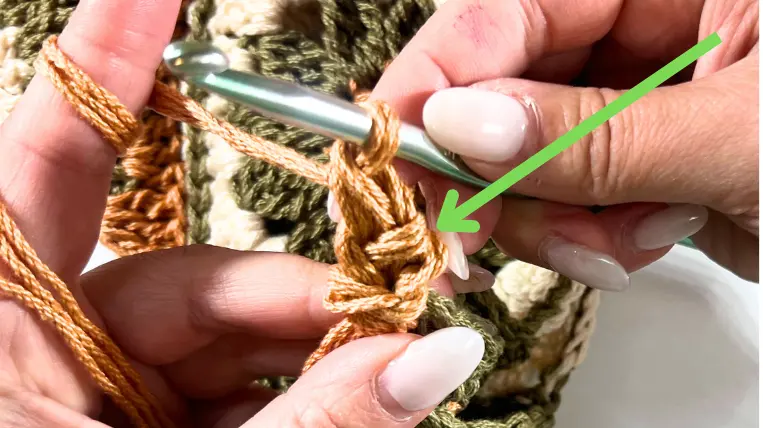 Another highlighted single crochet stitch with an arrow pointing to it for clarity.