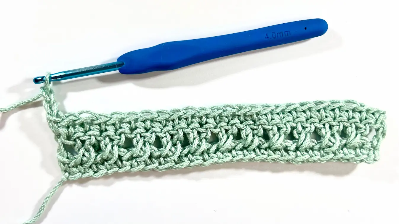 Completed row of Crossed Double Crochet stitches with a straight edge, ready for the next row or a turning chain.