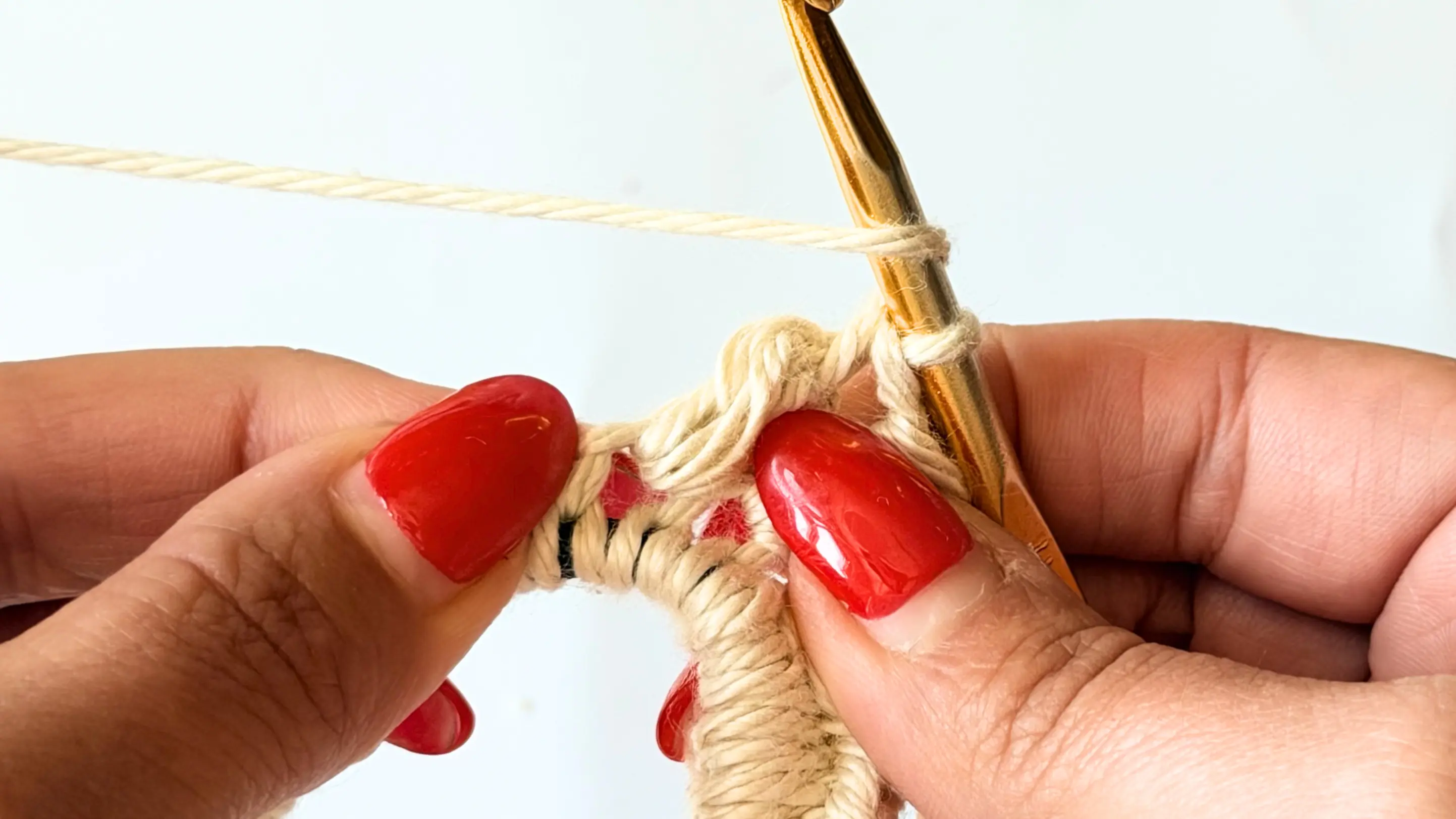 Completed first puff stitch worked into the crochet heart scrunchie.