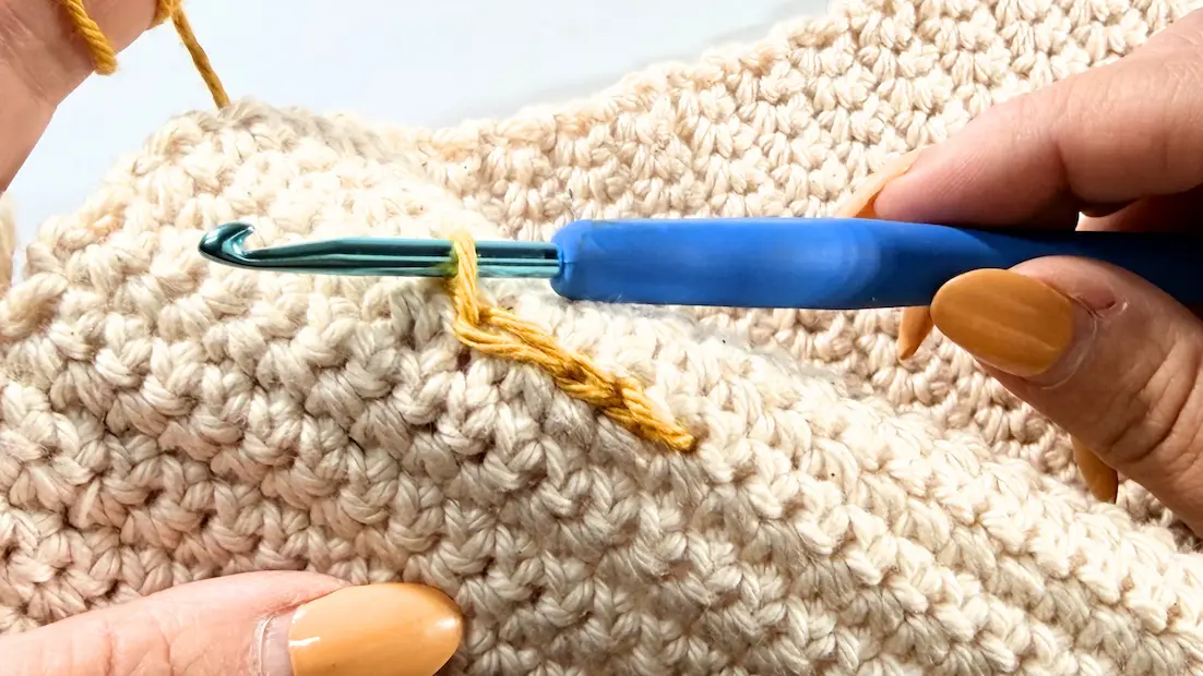Continuing the surface crochet design by working the next surface slip stitch.