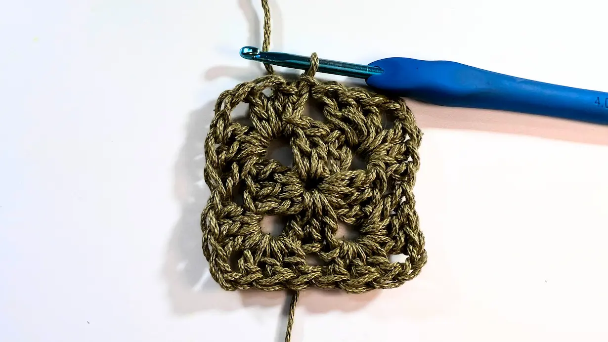 Granny square showing all four corners worked with chain spaces, closed round.