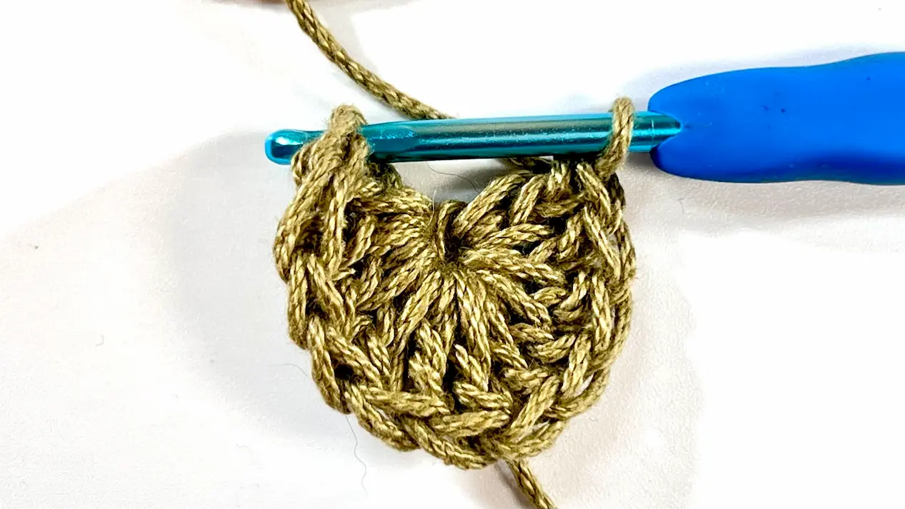 Crocheting the first round of stitches into the centre ring for the Daisy Square.