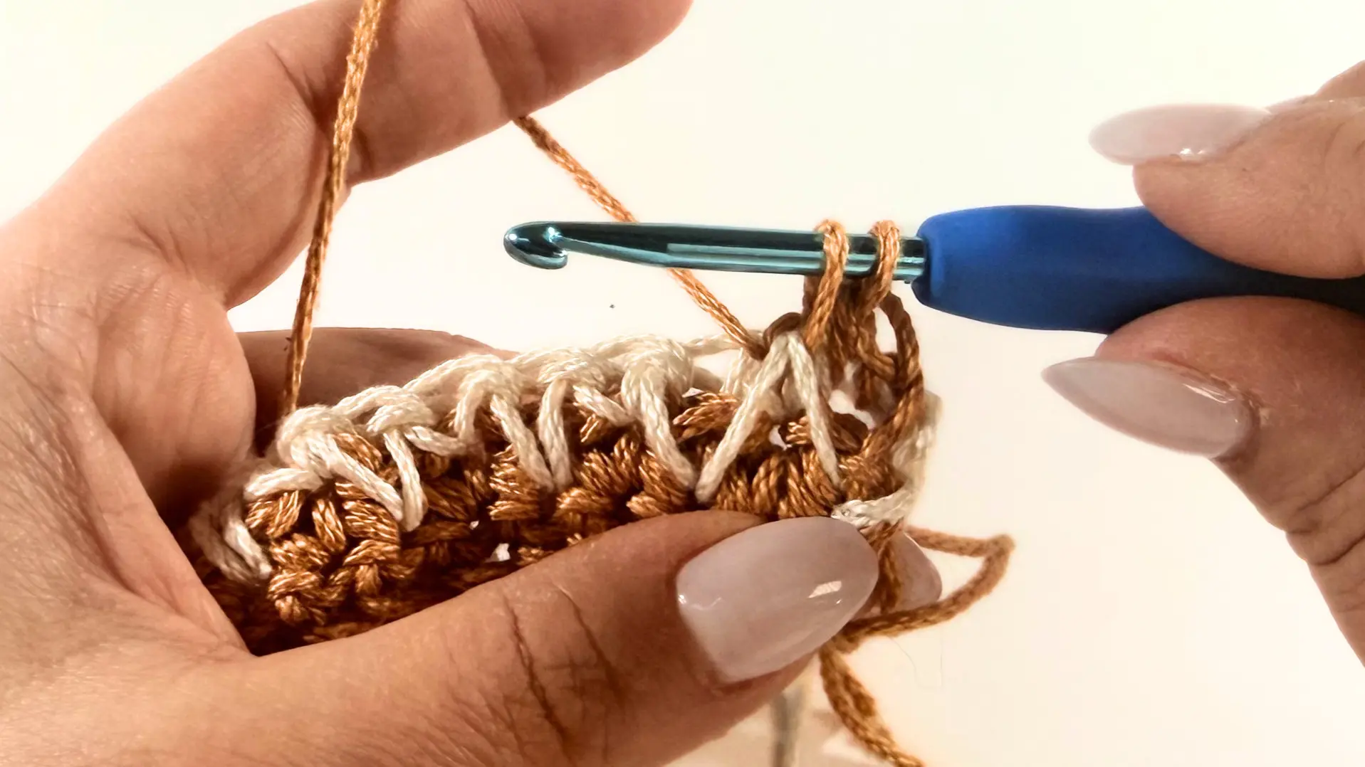 Pulling up a loop to connect the two legs.