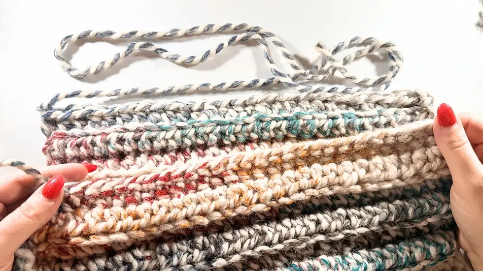 Progress view of chunky crochet hat body worked in rows, displaying thick textured stitches in super bulky wool blend yarn.