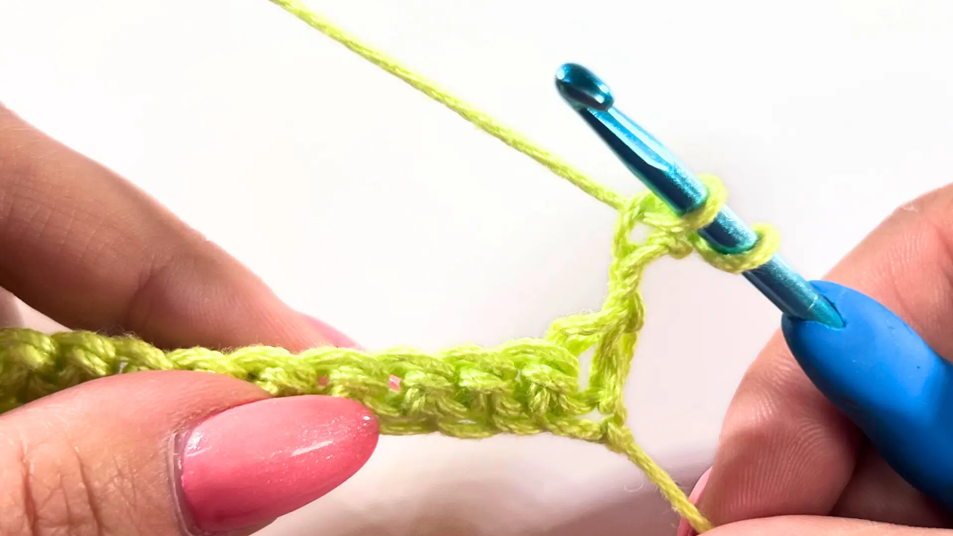 Hook inserted into the second chain from the hook to begin forming the Star Stitch, with two loops on the hook.