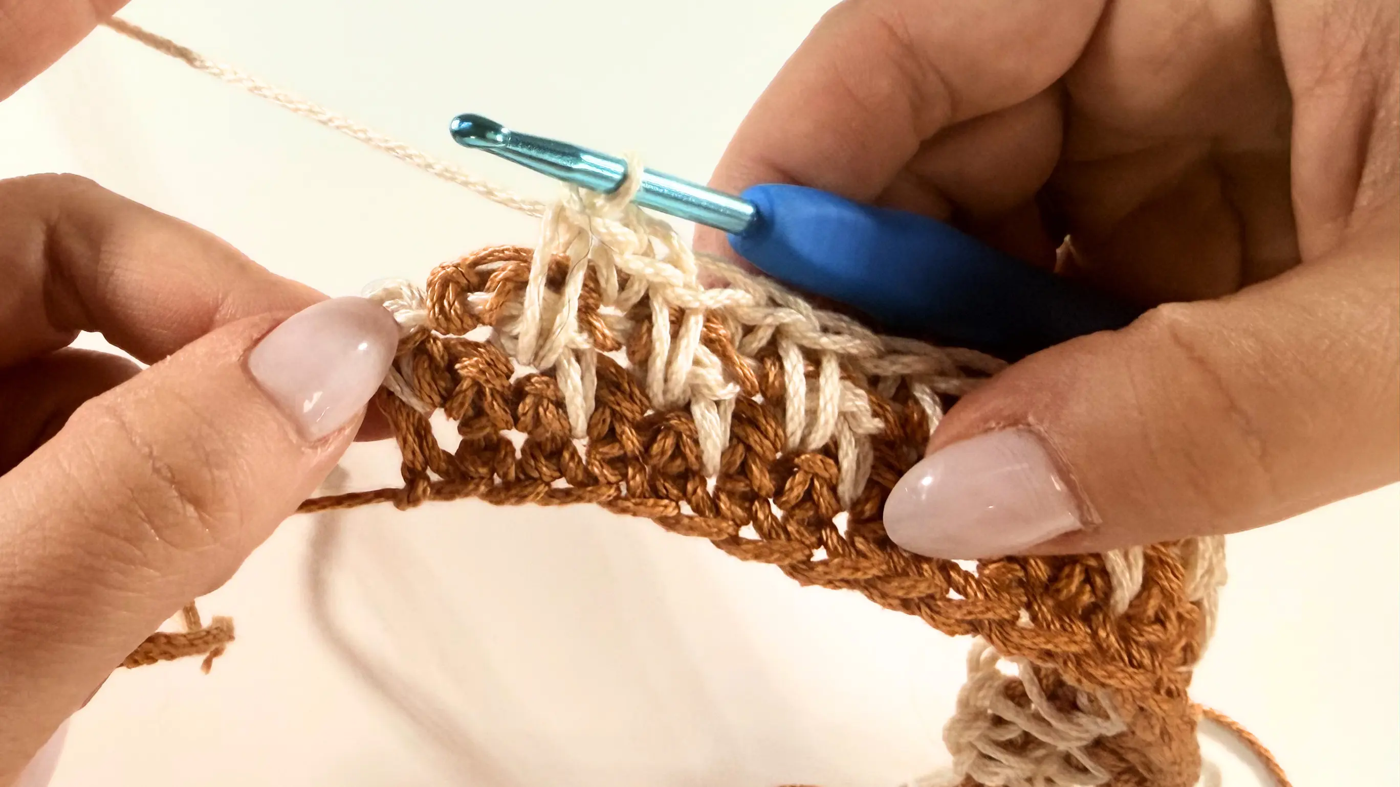 Making the last Single Crochet to complete Row 5 of the Honeycomb Stitch.