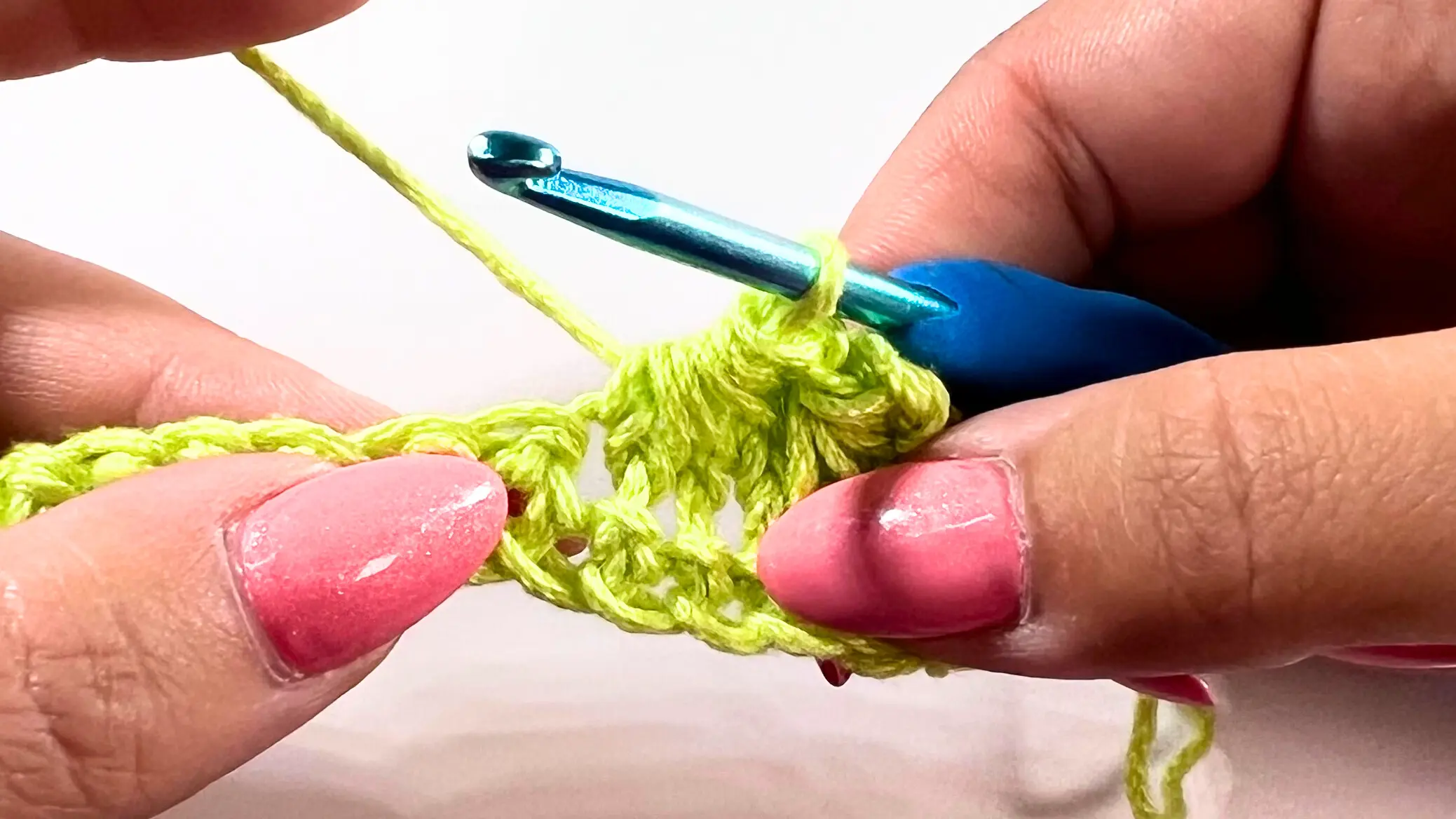 Yarn over and pull-through in progress, completing the second Star Stitch.