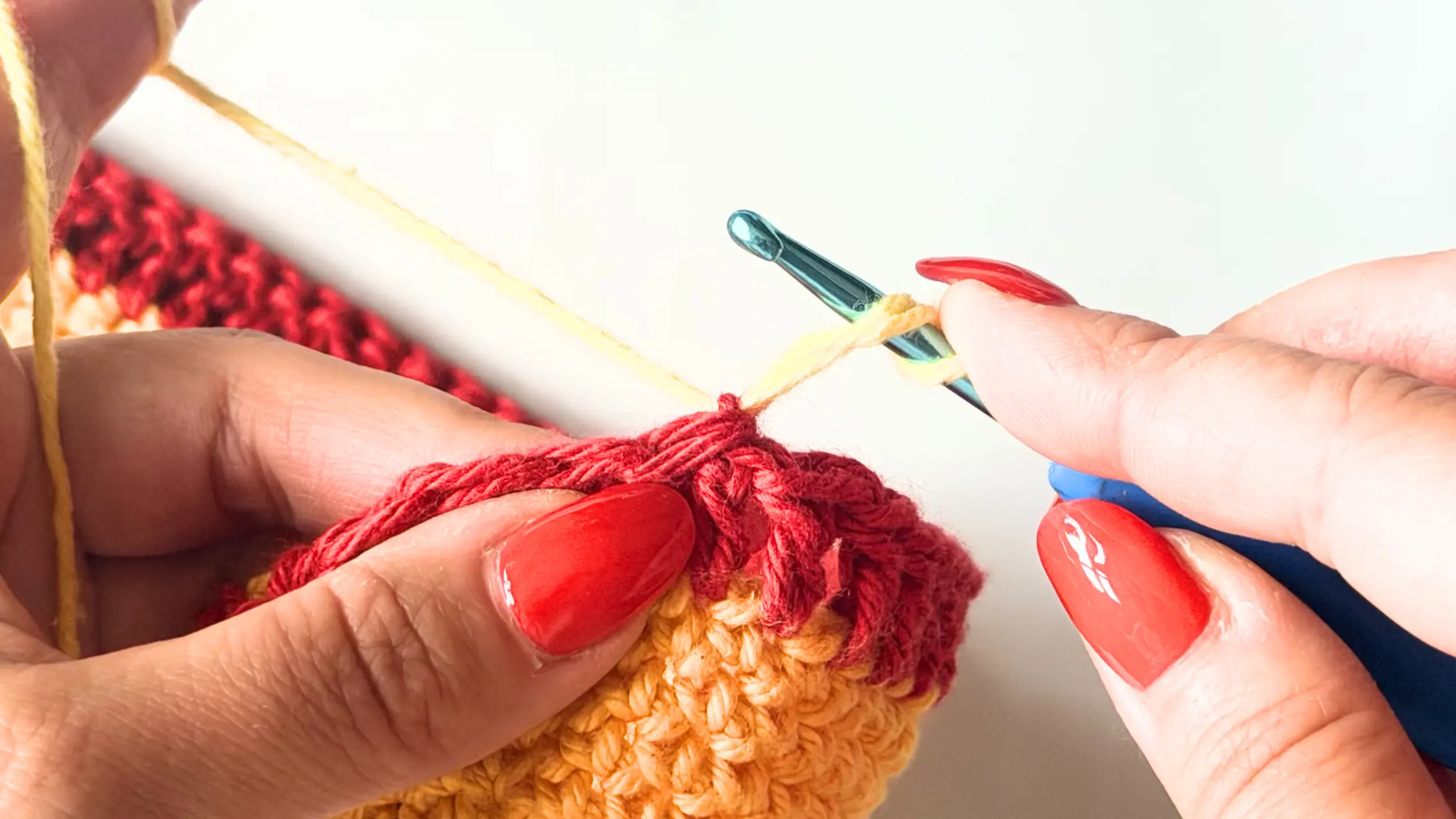 Yarn over to begin the invisible standing double crochet.