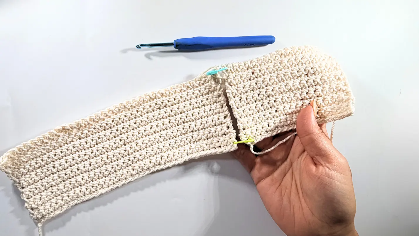 Long crochet panel and short crochet panel aligned together with stitch markers before seaming.