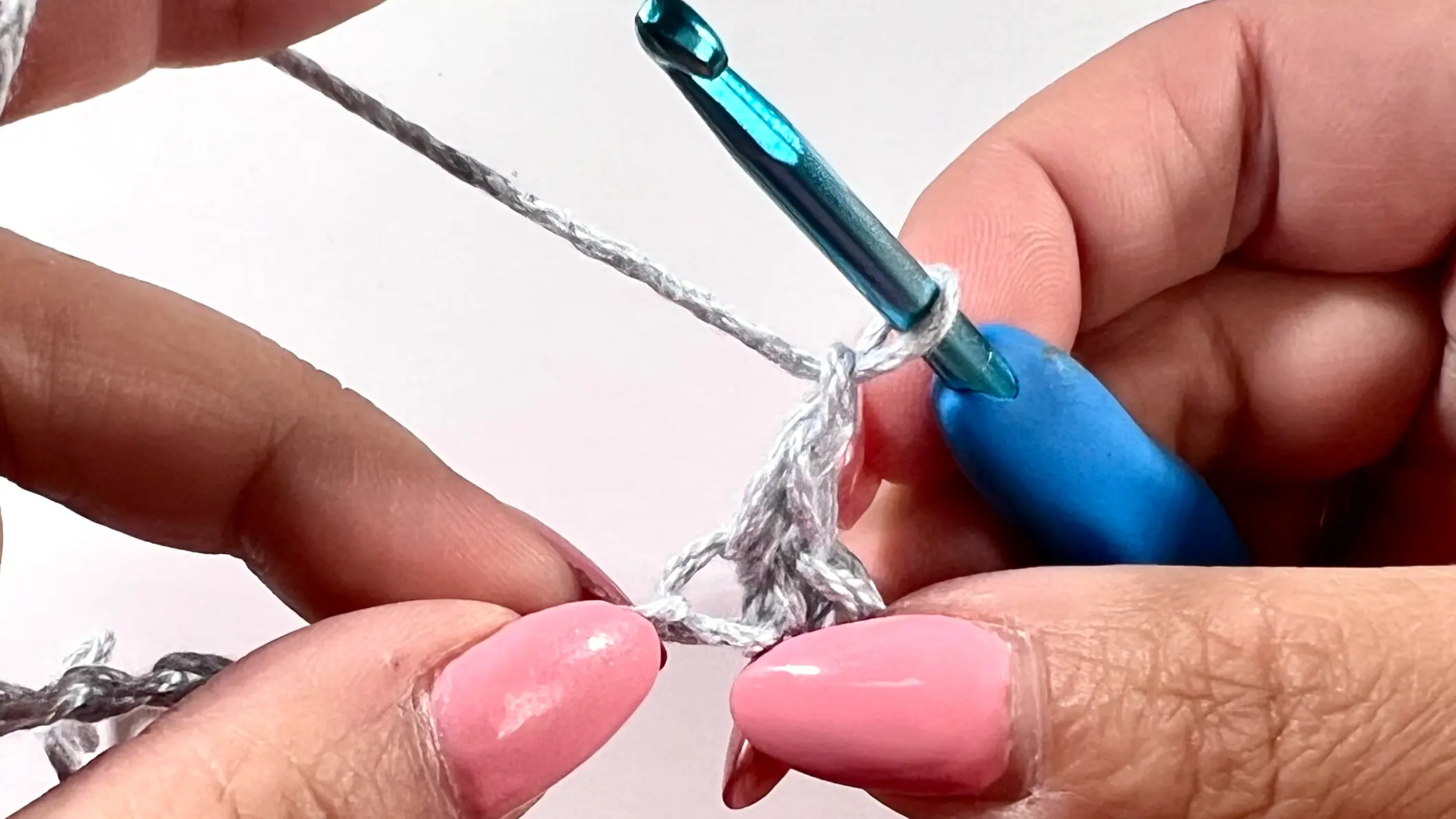 Second step of crocheting a spider stitch. One chain added into the stitch.