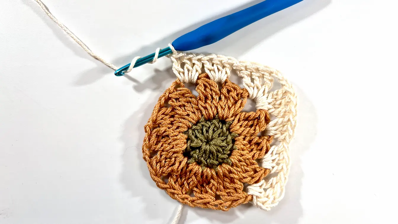 Finished Daisy Granny Square with all four corners worked, forming a complete square.