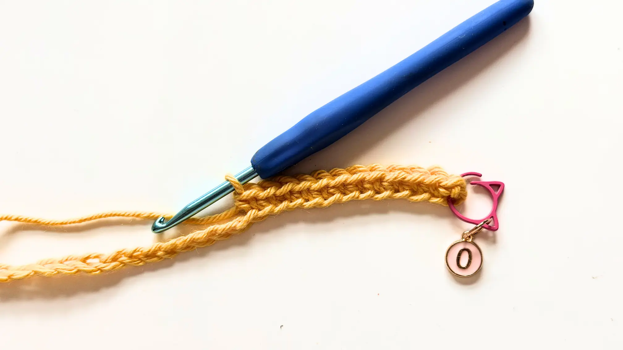 Crocheting the first round of the Summer Beach Tote by working Single Crochet around the foundation chain.
