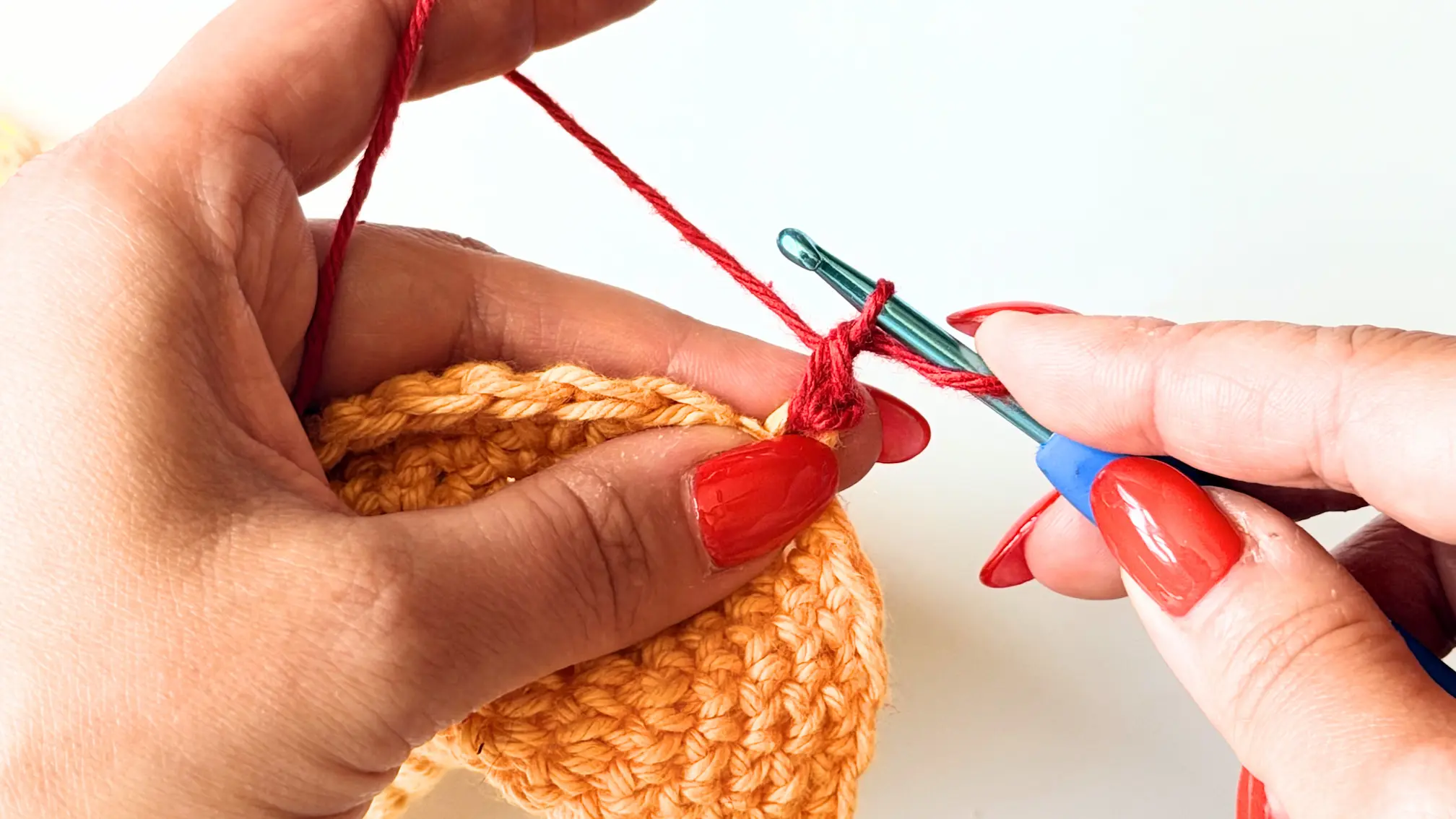 Yarn over and pull through the remaining two loops to complete the first invisible Double Crochet.