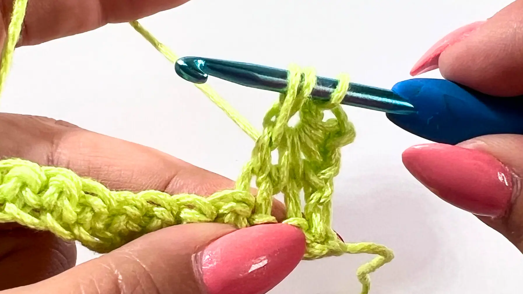 Hook positioned to pull up loops between the posts of the previous star stitch.