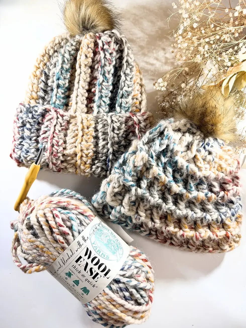 Thumbnail: Two chunky crochet beanies with pom poms and super bulky yarn