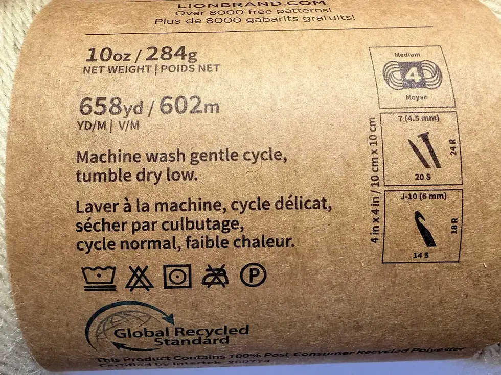 Close-up of yarn label showing yarn weight, hook size, yardage and care instructions for crochet