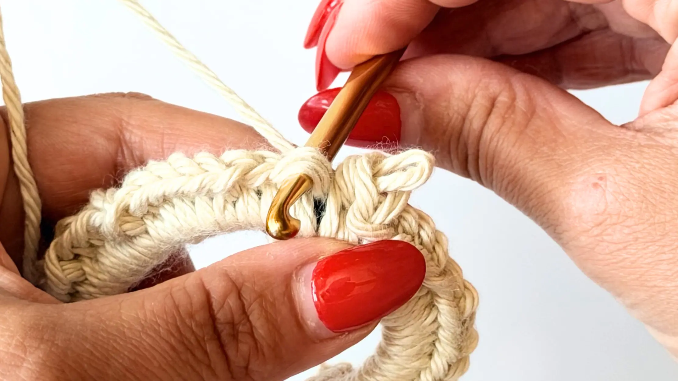 Inserting the hook into the first stitch for an invisible join