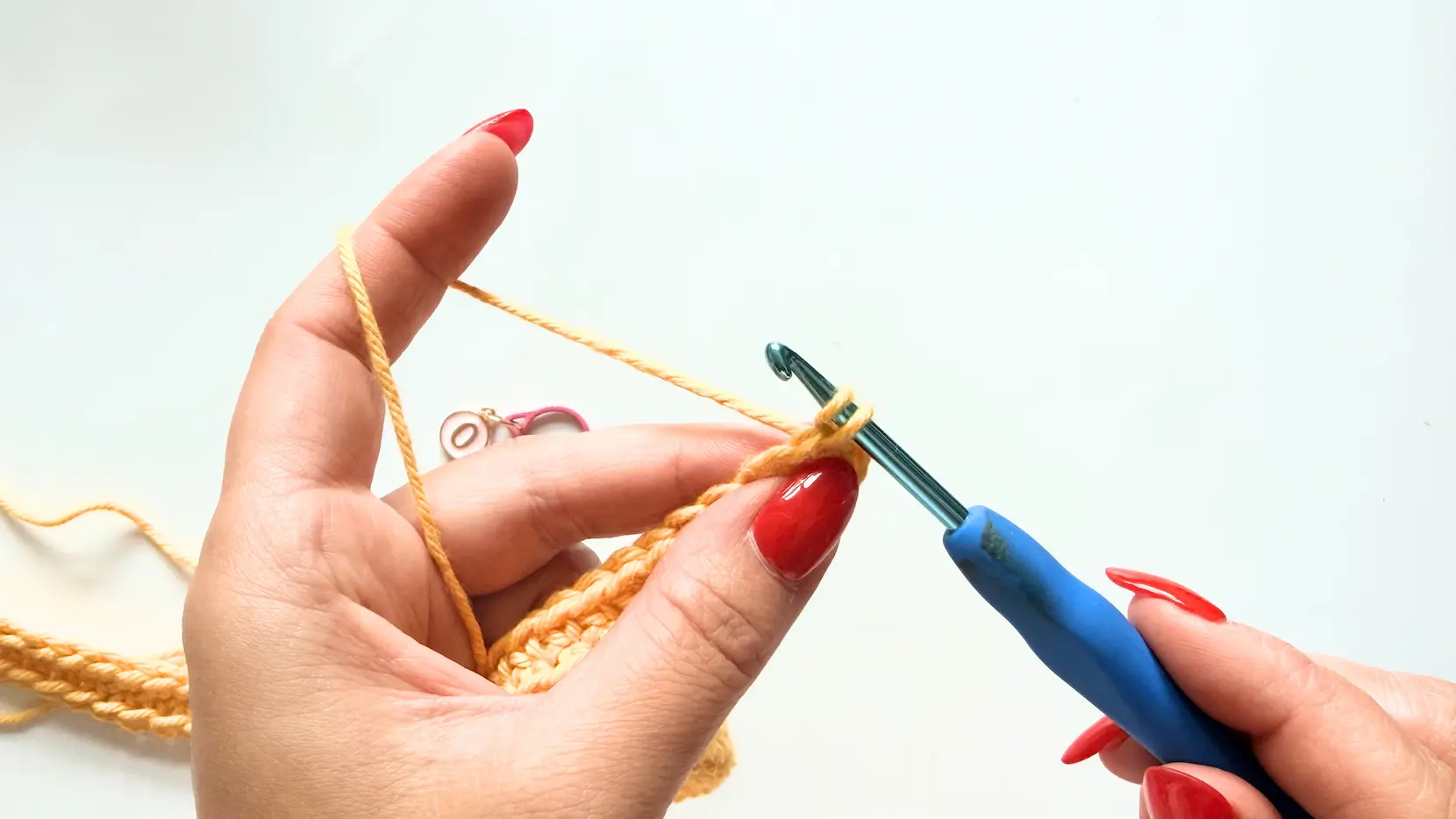 Pulling the loop through the first Single Crochet while making the Invisible Join in the round.