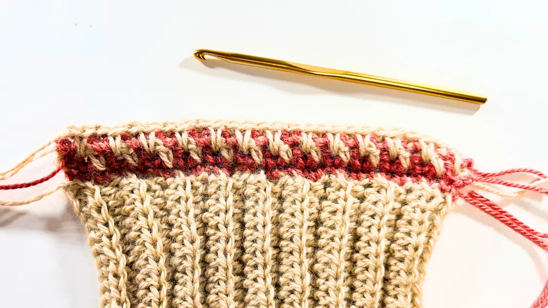 Honeycomb stitch crochet row completed with alternating spike stitches and single crochet stitches