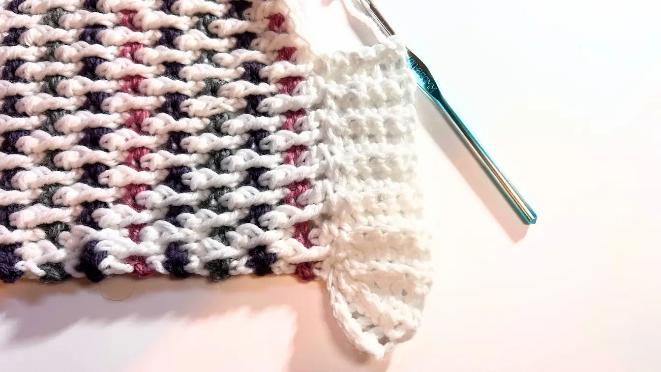 Completed ribbed border section attached to the blanket, showing raised texture and neat finish.