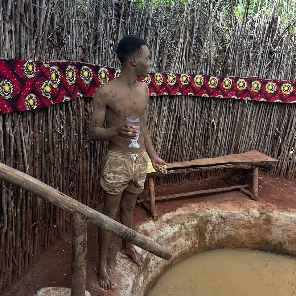 Man standing up during a Mud Bath session at Enjoying a rustic mud spa treatment at Alis Acre Farm 