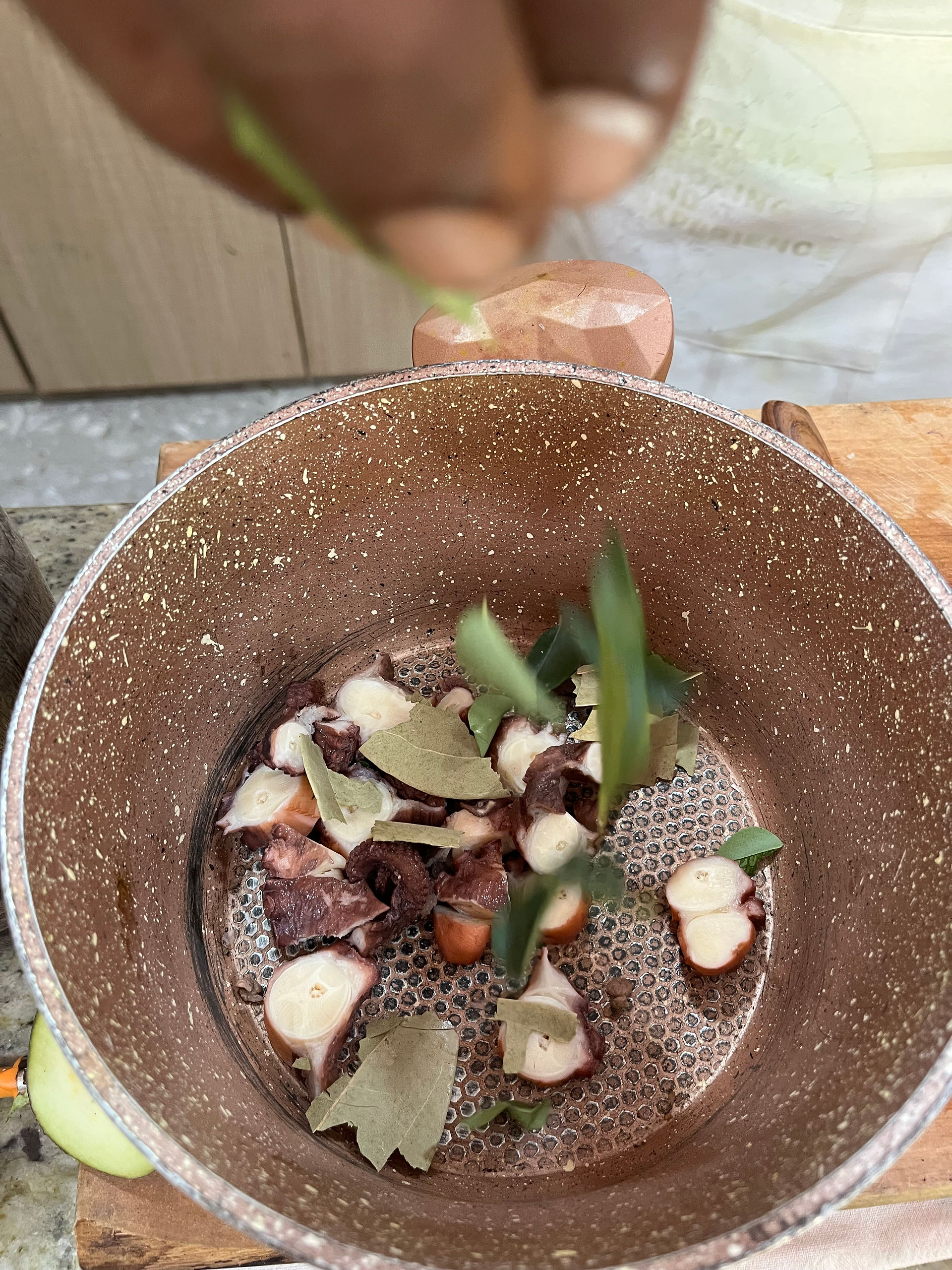 Preparing the octopus by cutting in slices at Chef George Kitchen, La Digue