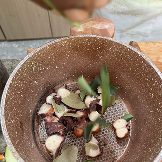 Preparing the octopus by cutting in slices at Chef George Kitchen, La Digue