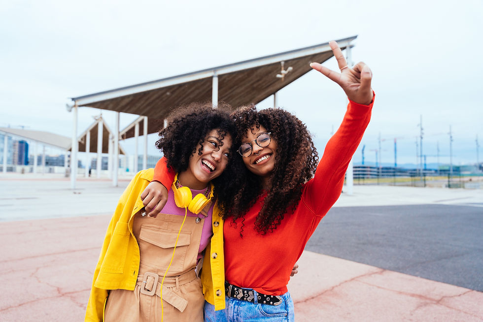 Two friends dress colourfully happy to wave at the airport tarmac
