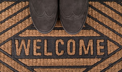 Potential donor shoes on a tweed welcome mat.