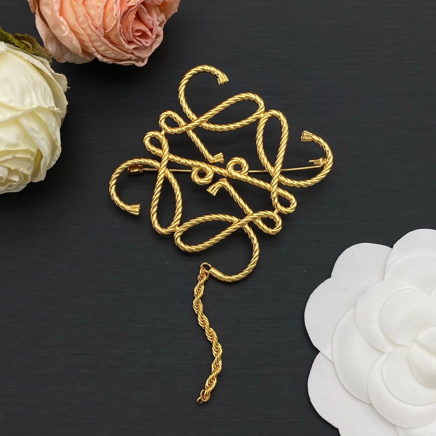 Lo*we gold brooch 