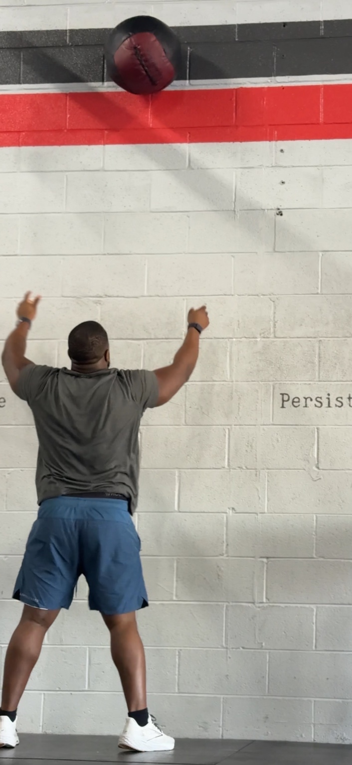 Cardinal athlete doing wall balls