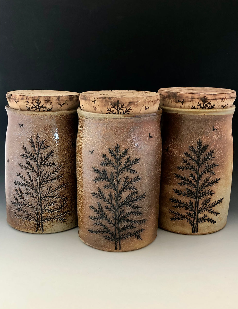 Handcrafted stoneware pine tree jars with cork lids