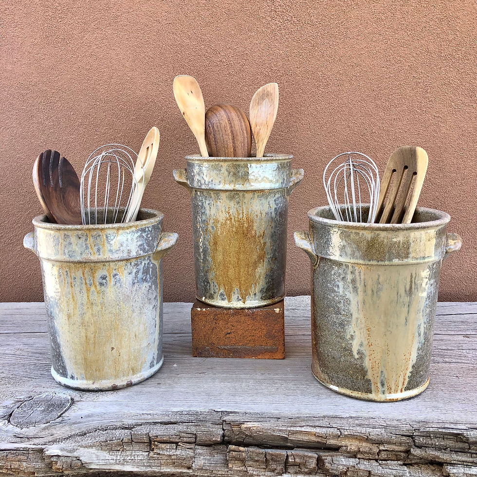 Stoneware utensil holder crocks with spoons inside