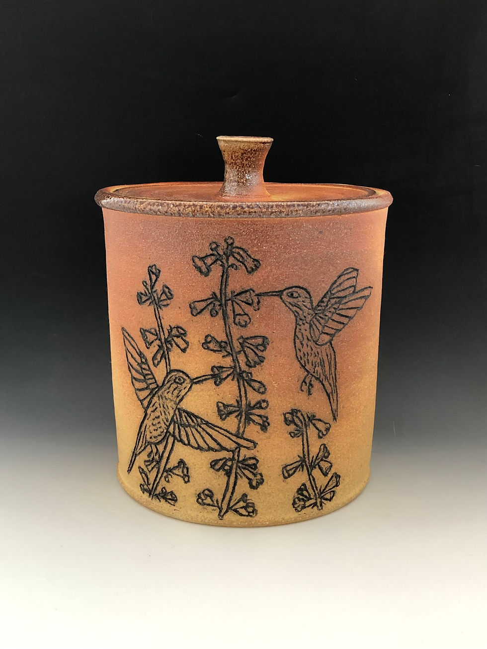 Large hand carved hummingbird pottery jar made at Earthfired Pottery