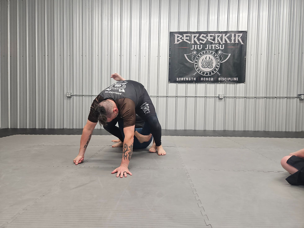 A student uses a De La Riva sweep to take down a much larger opponent.
