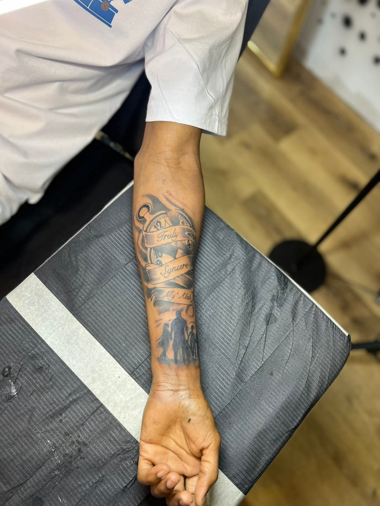 Arm with tattoo art, Lucky's tattoo work visible, detailed grayscale art on arm. American Adrenaline