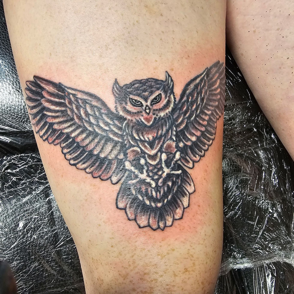 Owl tattoo with spread wings on the leg, detailed Lucky's tattoo work, American Adrenaline.