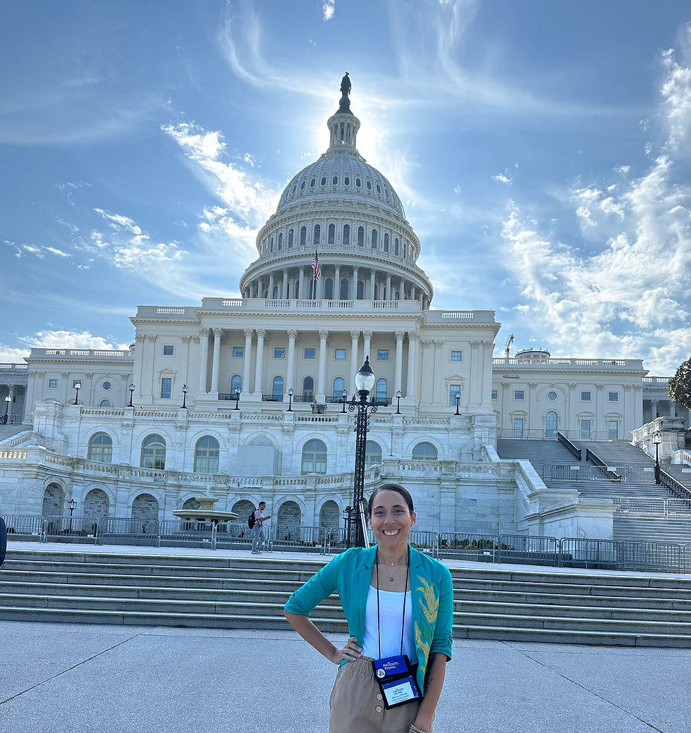 A woman standing in front of the US capitol wearing a custom blazer