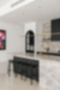 decorative battens in an architectural interior kitchen design with gold tapware black battens half round and marble benchtops