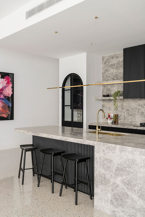 decorative battens in an architectural interior kitchen design with gold tapware black battens half round and marble benchtops