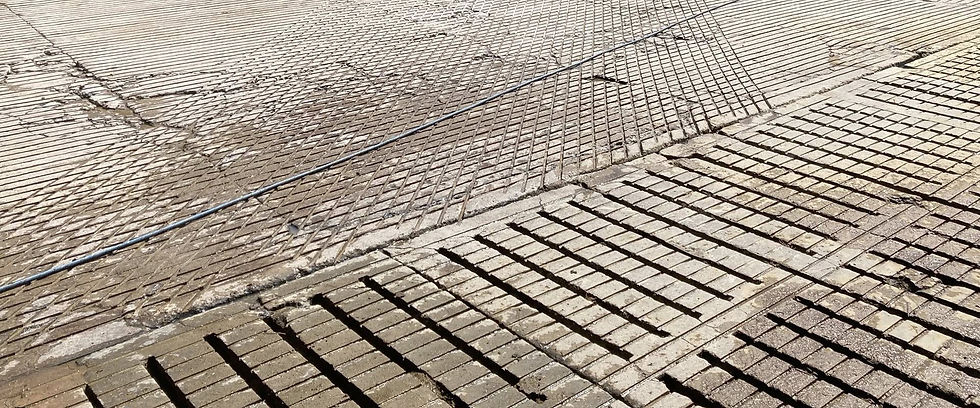 Close-up of textured brickwork with intersecting diagonal lines, creating a dynamic pattern