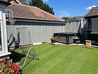 A back garden with artificial grass