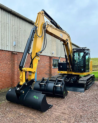 A brand new, yellow CAT mini digger with two black buckets