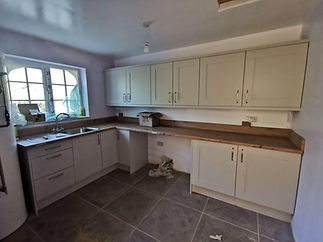 Cream fitted kitchen cabinetry with wooden worktops and corner sink