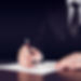  A legal advisor holding a fountain pen ready to sign a document