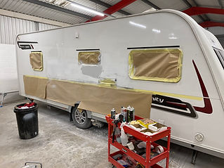 A white caravan inside a workshop
