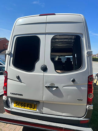 Rear view of a white van showing professional twin rear window conversion