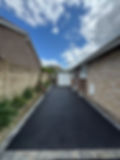 A tidy driveway leads to a white garage