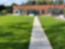 A large garden with a new stone path and lush