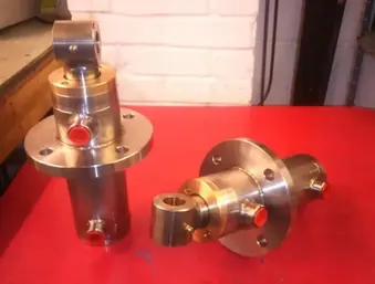 Two shiny metal hydraulic cylinders